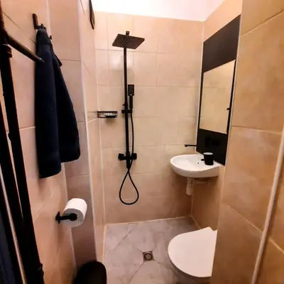a bathroom with a shower and a toilet and a sink at Lucky number 7 Studio in Sofia
