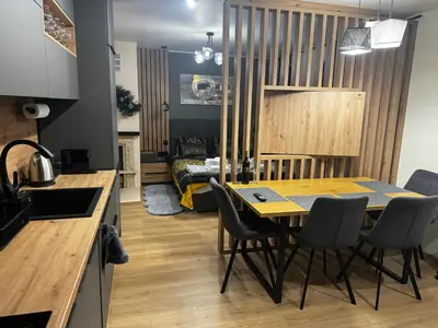 a kitchen and dining room with a table and chairs at Avelov Art Studio in Pamporovo