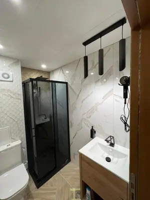 a bathroom with a sink and a shower and a toilet at Avelov Art Studio in Pamporovo