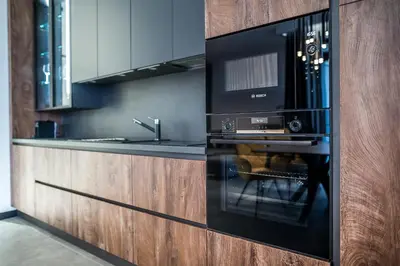 a microwave oven in a kitchen with a counter at ARHEYA 1 apart Архея 1 апартамент за гости in Karlovo