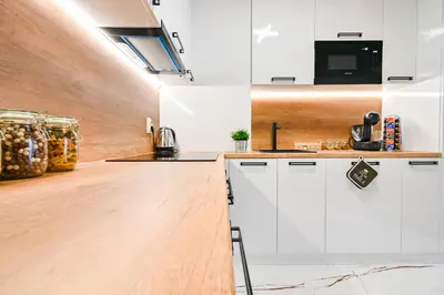 a kitchen with white cabinets and a counter top at Armand de Azurro in Sofia