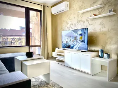 a living room with white furniture and a flat screen tv at Beautiful & Comfy Apartment for 4 Guest and Free Parking in Plovdiv