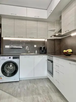 a kitchen with white cabinets and a washing machine at Beautiful & Comfy Apartment for 4 Guest and Free Parking in Plovdiv