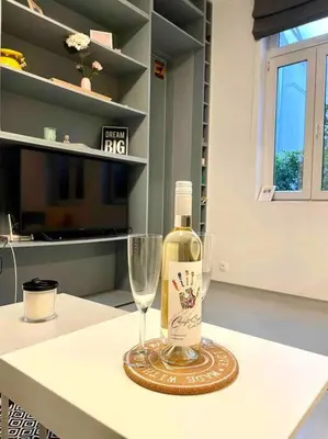 a bottle of wine and a wine glass on a table at Heart of the city in Sofia