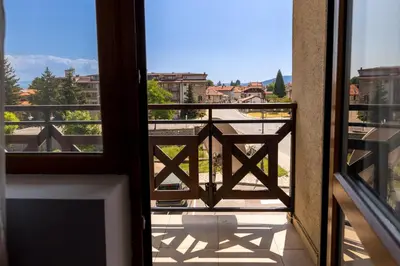 a view from a window of a balcony at One bedroom apartment in Hotel Banderitsa ,Bansko in Bansko