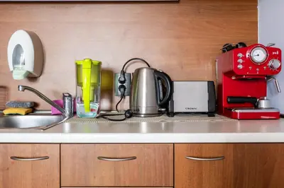 a kitchen counter with a sink and a red appliance at One bedroom apartment in Hotel Banderitsa ,Bansko in Bansko