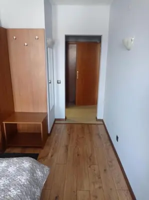 a bedroom with a bed and a wooden floor at One bedroom apartment in Hotel Banderitsa ,Bansko in Bansko