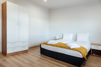 a bedroom with a large bed and a dresser at VILLA MEDI boutique in Sapareva Banya