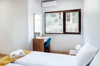 a bedroom with a bed and a desk and a window at VILLA MEDI boutique in Sapareva Banya