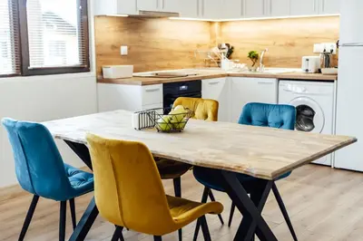 a kitchen with a wooden table and chairs at VILLA MEDI boutique in Sapareva Banya