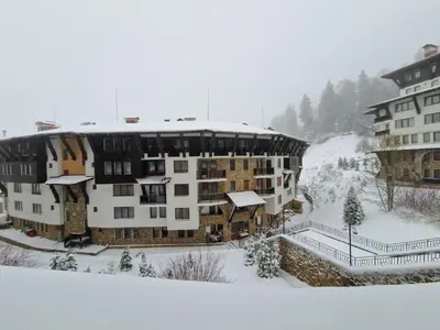 a large building in the snow with snow at Snowy tale in Pamporovo