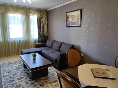 a living room with a couch and a table at Snowy tale in Pamporovo