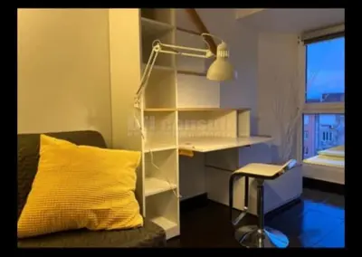 a room with a desk and a yellow pillow and a lamp at Sky-view apartmentin perfect city center Sofia in Sofia