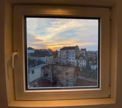 a window with a view of a city at Sky-view apartmentin perfect city center Sofia in Sofia