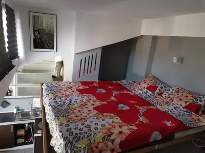 a bedroom with a bed with a floral bedspread at Sky-view apartmentin perfect city center Sofia in Sofia