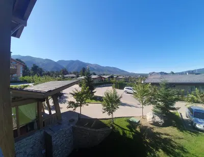 a view of a parking lot with mountains in the background at Pirin Golf Guest Room in Razlog