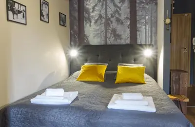 a bed with yellow pillows and towels on it at Borovets Dream Studio in Borovets