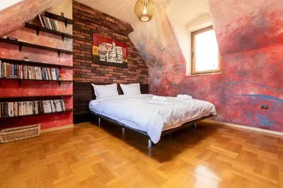 a bedroom with a bed and a brick wall at Penthouse Tepeto in Plovdiv