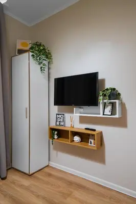 a living room with a tv and a white refrigerator at Tom Thumb & Thumbelina - 2 Private Rooms in Sofia Center by Flat Mаnager in Sofia
