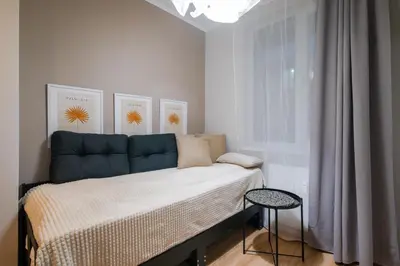 a small bedroom with a bed and a window at Tom Thumb & Thumbelina - 2 Private Rooms in Sofia Center by Flat Mаnager in Sofia