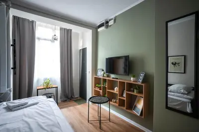 a bedroom with a bed and a table and a mirror at Tom Thumb & Thumbelina - 2 Private Rooms in Sofia Center by Flat Mаnager in Sofia