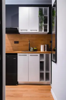 a kitchen with white cabinets and a black dishwasher at Tom Thumb & Thumbelina - 2 Private Rooms in Sofia Center by Flat Mаnager in Sofia