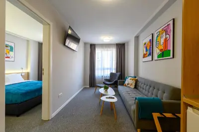 a hotel room with a couch and a bed at LOCATION in Sofia