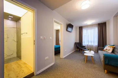 a living room with a couch and a chair at LOCATION in Sofia