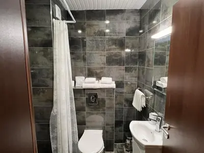 a bathroom with a toilet and a sink at Апартамент Комфорт 2 Близо до Летището in Sofia