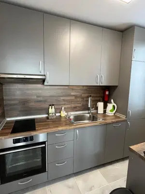 a kitchen with silver cabinets and a sink at Апартамент Комфорт 2 Близо до Летището in Sofia