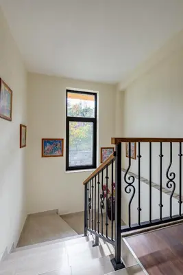 a staircase in a home with a window at ВИЛА МАРИНОВИ in Boykovo