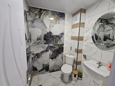 a bathroom with a toilet and a sink at Апартамент за гости Боляри in Velingrad