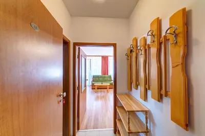 a hallway with a locker room with a bench at Cozy Studio in Hotel Laplandia, Pamporovo by Flat Mаnager in Pamporovo