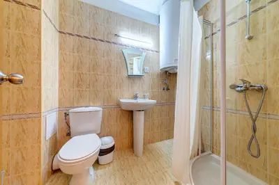 a bathroom with a toilet and a sink and a shower at Cozy Studio in Hotel Laplandia, Pamporovo by Flat Mаnager in Pamporovo