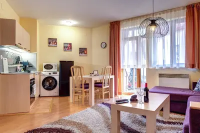 a living room with a couch and a table at 1BD Ski View Retreat in Pamporovo with Fireplace by Flat Mаnager in Pamporovo