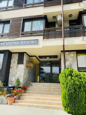 a building with stairs leading to a seasons resort at Studio El - All seasons in Bansko