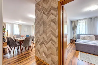 a living room and dining room with a bed and a table at Luxury Flat in Grand Resort Pamporovo by Flat Mаnager in Pamporovo