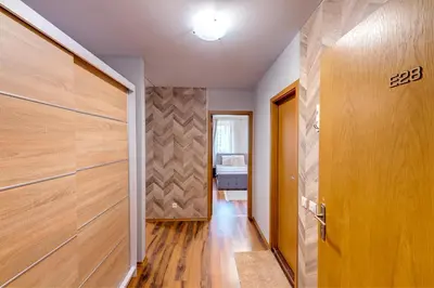 a hallway with wooden doors in a house at Luxury Flat in Grand Resort Pamporovo by Flat Mаnager in Pamporovo