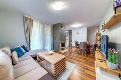 a living room with a couch and a table at Luxury Flat in Grand Resort Pamporovo by Flat Mаnager in Pamporovo