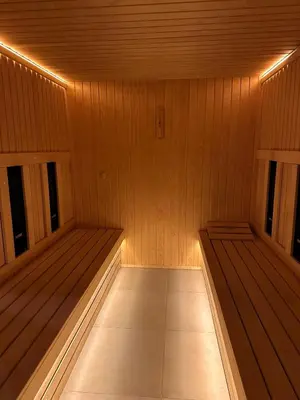 a sauna with two benches in a wooden room at Sana Ski apartment 313A in Flora, Borovets in Borovets