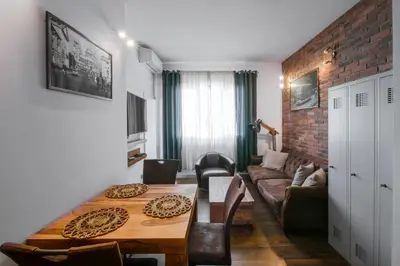 a living room with a table and a couch at Designer 1BD Cinématique on Solunska by Flat Mаnager in Sofia