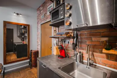 a kitchen with a sink and a brick wall at Designer 1BD Cinématique on Solunska by Flat Mаnager in Sofia