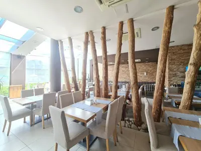 a restaurant with wooden tables and chairs and a brick wall at Aspen Golf D 401 in Bansko