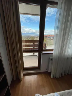 a room with an open door with a view of a balcony at Belvedere Holiday Club ,apartment A202 in Bansko