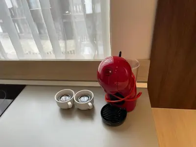 a red blender sitting on a counter with two bowls at Belvedere Holiday Club ,apartment A202 in Bansko