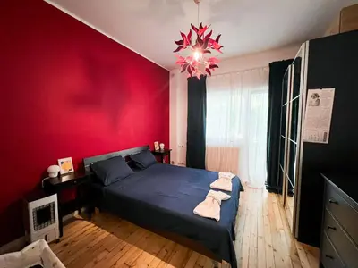 a bedroom with a blue bed and a red wall at Perfect Long-term Stay Stylish and Spacious Top Center Next to Vitosha Blvd in Sofia