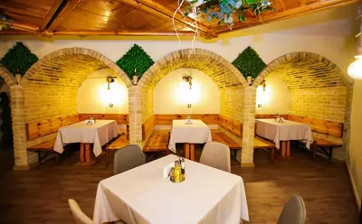 a restaurant with three tables with white table cloth at Почивна станция - ТЕЦ Бобов дол in Bistriza