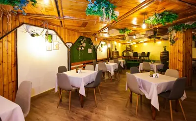 a dining room with white tables and chairs at Почивна станция - ТЕЦ Бобов дол in Bistriza