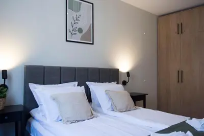 a bedroom with two beds with white pillows at Antonovi Apartments Deluxe in hotel Laplandia in Pamporovo