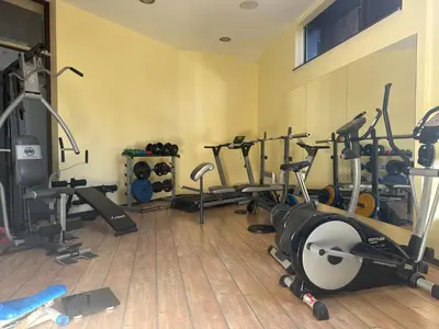a gym with several treadmills and exercise bikes at Alpine Lodge Bansko Apartments in Bansko